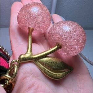 Cherry Pink sparkles with gold leaf clips onto your coach purse